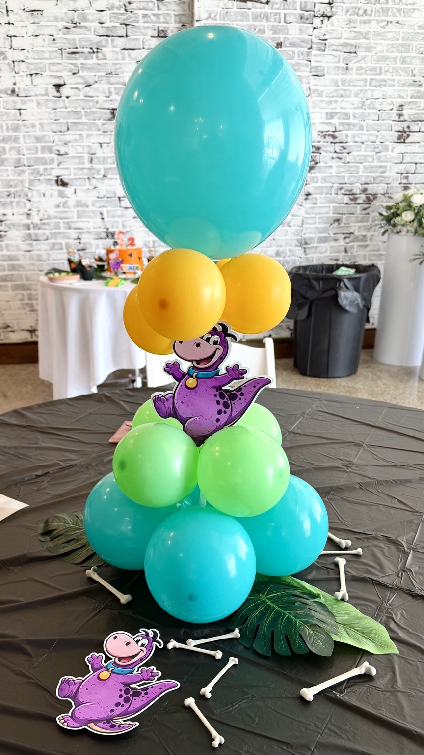 Colorful dinosaur balloon party setup