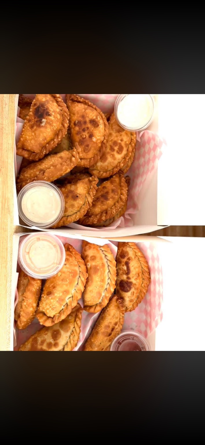 Boxed savory empanadas with dipping sauces