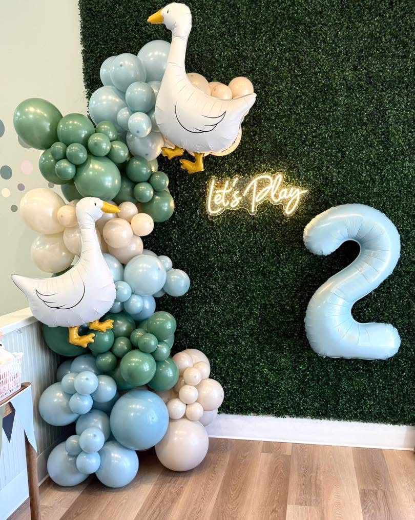 Goose themed balloon garland and grass wall