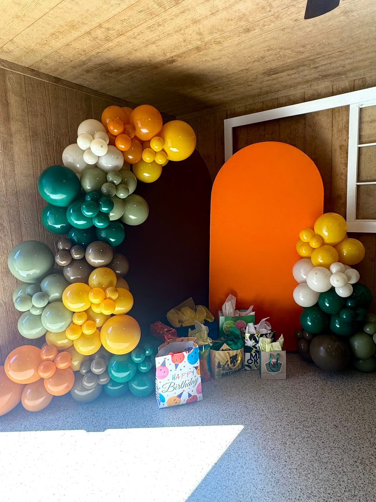 Orange green and neutral balloon arch setup